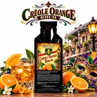 Créole Orange Rhum Essence pouch by Swish Barrel with fresh oranges, a crystal glass of amber rhum over ice, and colorful Mardi Gras masks and beads inspired by New Orleans.