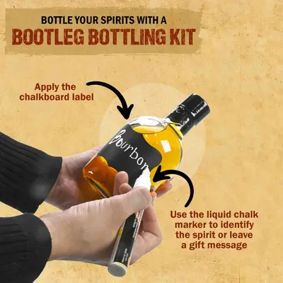 Person labeling a whiskey bottle with chalkboard sticker and liquid chalk marker from Bootleg Bottling Kit