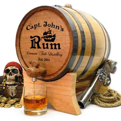 Pirate rum themed mini oak barrel aging whiskey with engraved captain design and spigot pouring aged spirit.